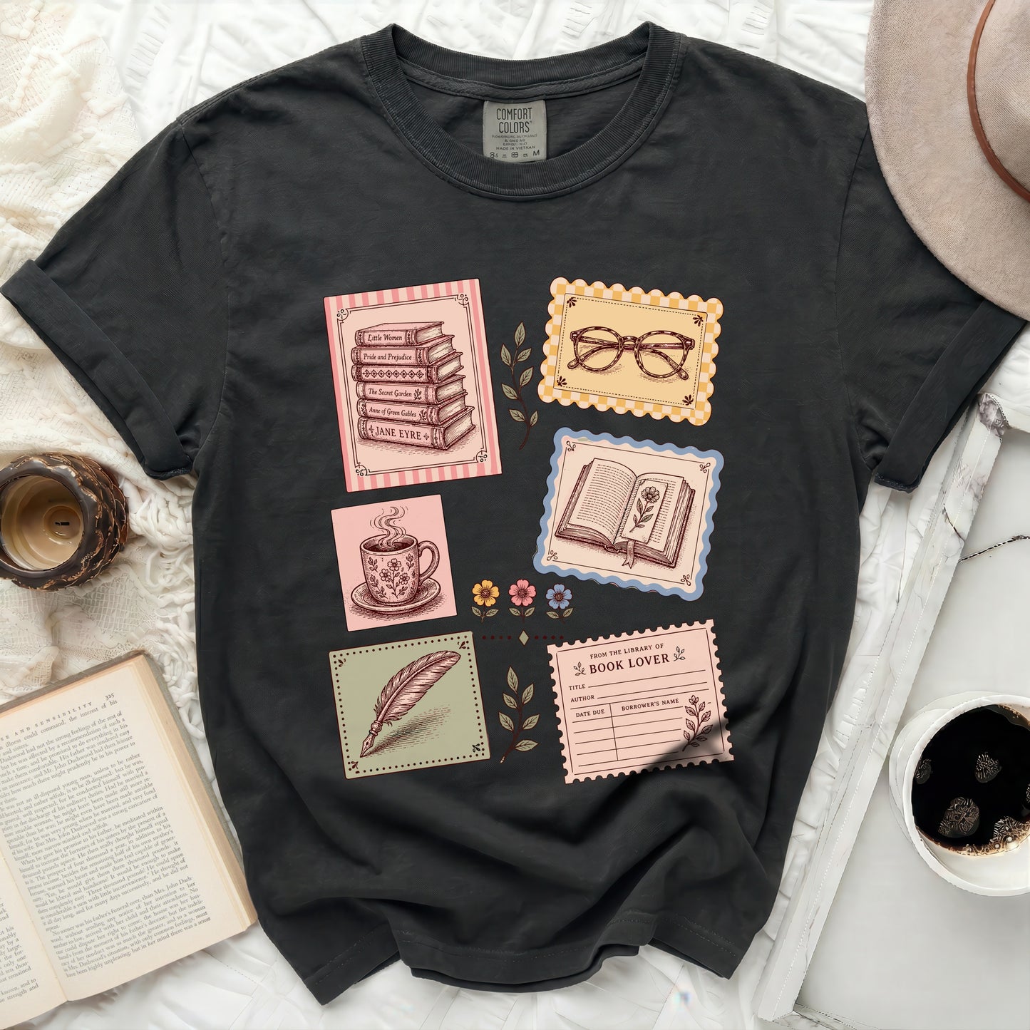 Black t-shirt with vintage book and stationery graphic print.
