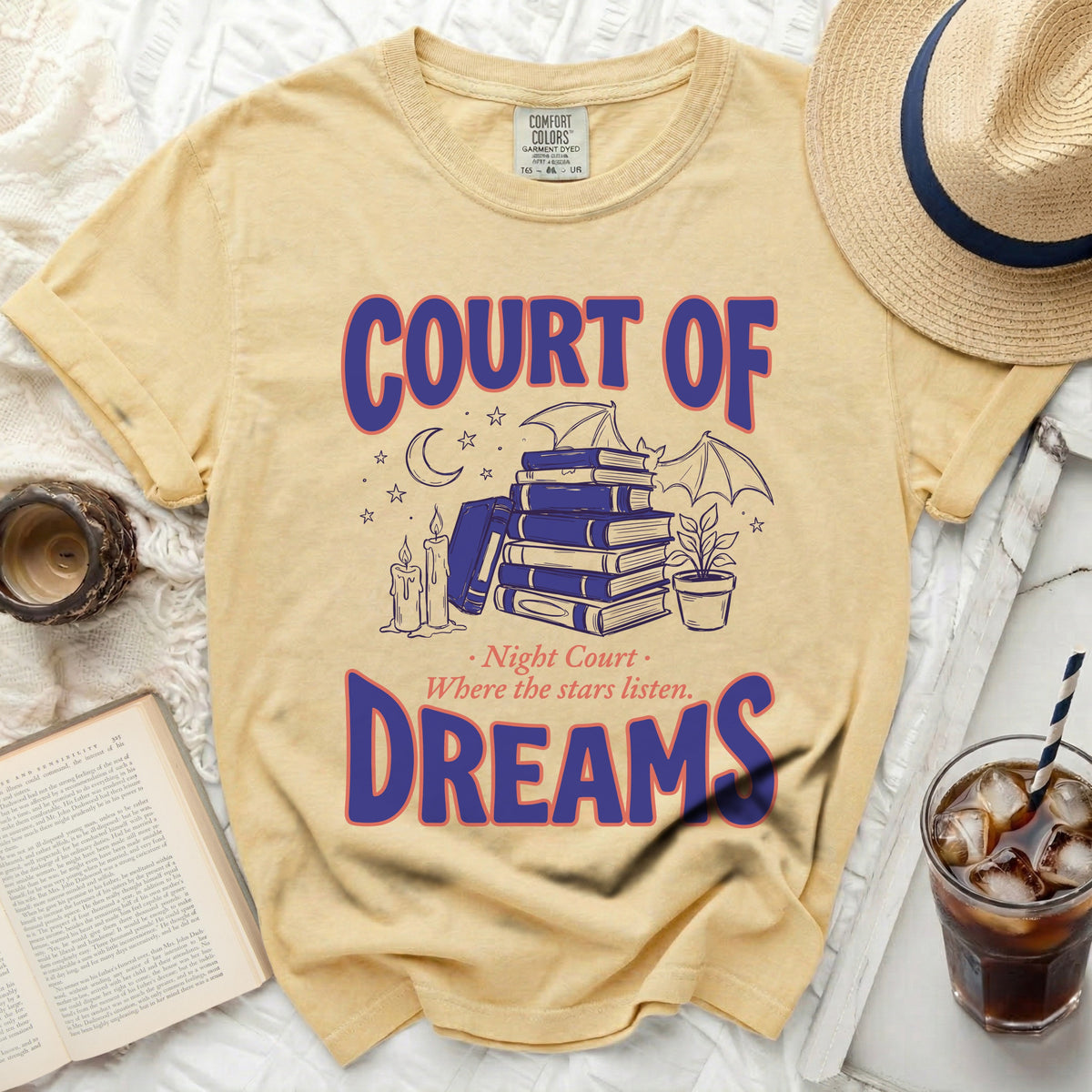 Yellow t-shirt with "COURT OF DREAMS" and book illustration.
