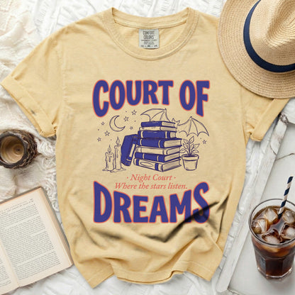 Yellow t-shirt with "COURT OF DREAMS" and book illustration.