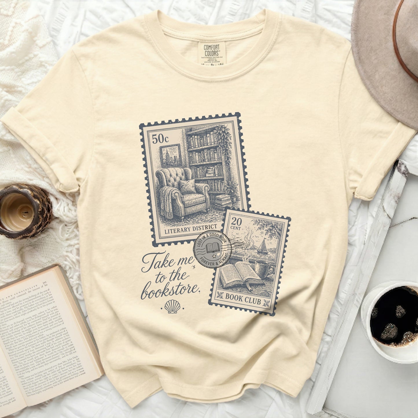 Cream t-shirt with "Take me to the bookstore" and vintage stamp graphic.