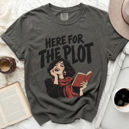 Grey t-shirt with "HERE FOR THE PLOT" text and a woman reading a book.