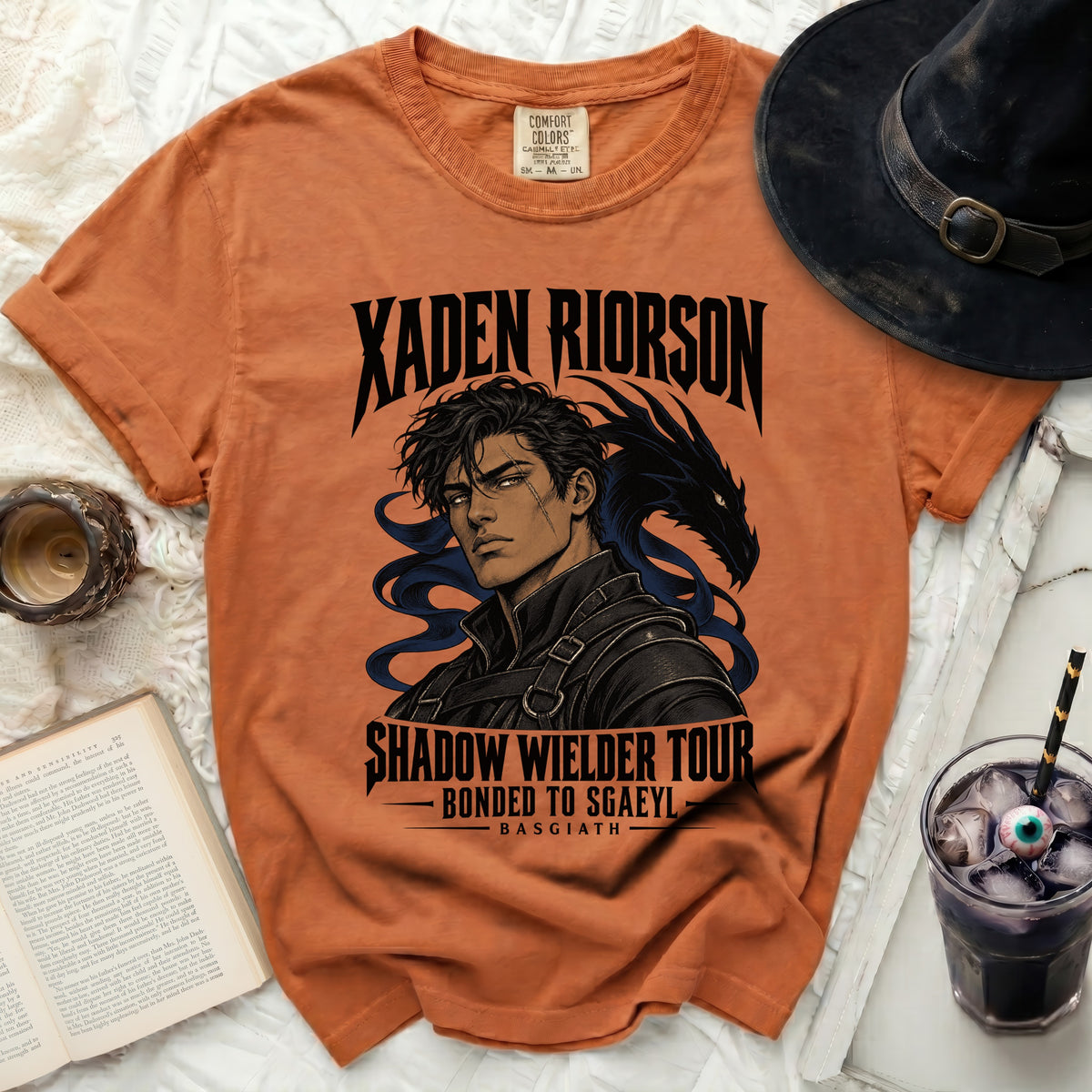 Orange t-shirt with Xaden Riorson and dragon artwork, "Shadow Wielder Tour," "Bonded to Sgaeyl," and "Basgiath" text.