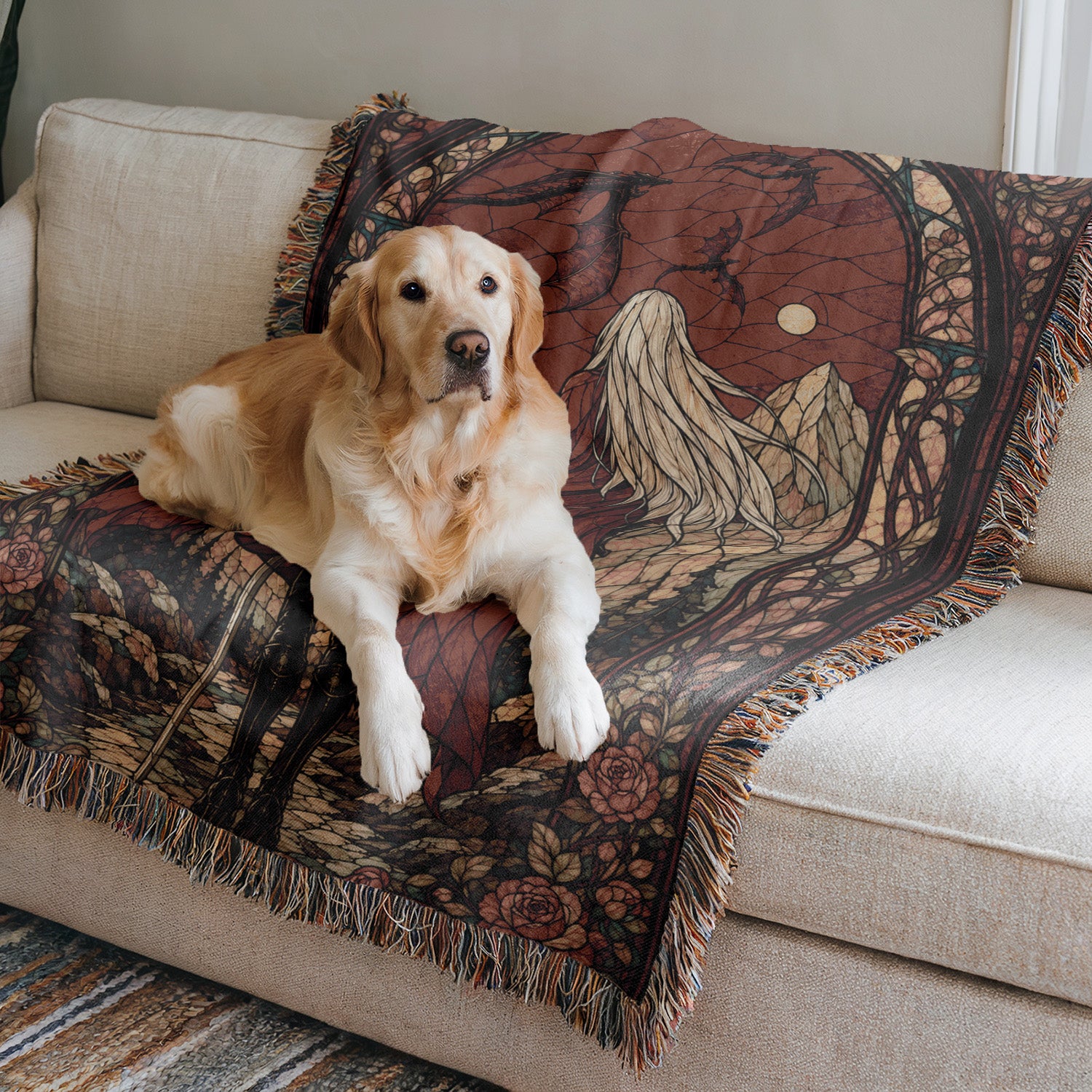 A golden retriever dog is lying on a patterned blanket on a couch.