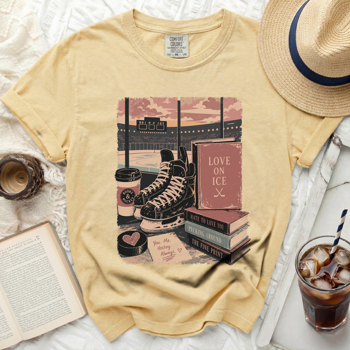 Yellow t-shirt with hockey and book graphics and text.