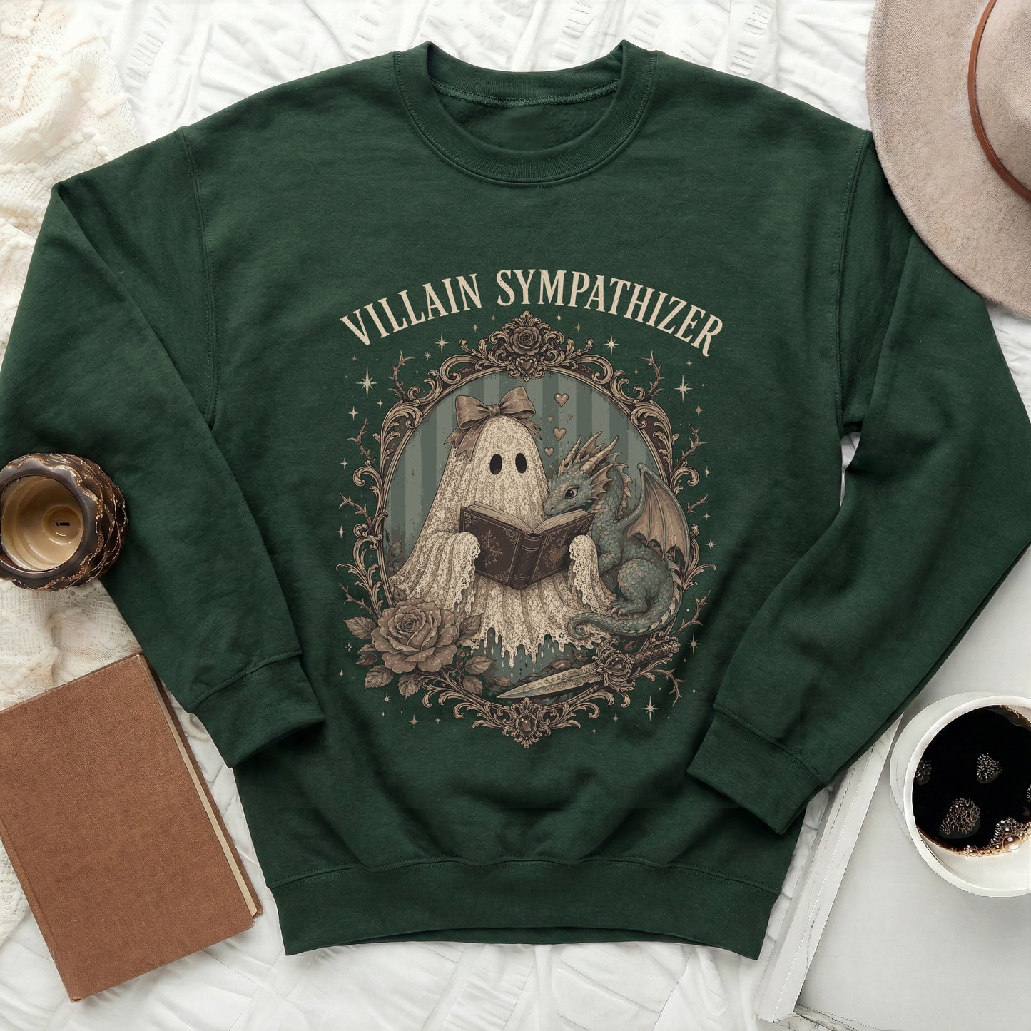 Green sweatshirt with "Villain Sympathizer" text and a ghost reading to a dragon.
