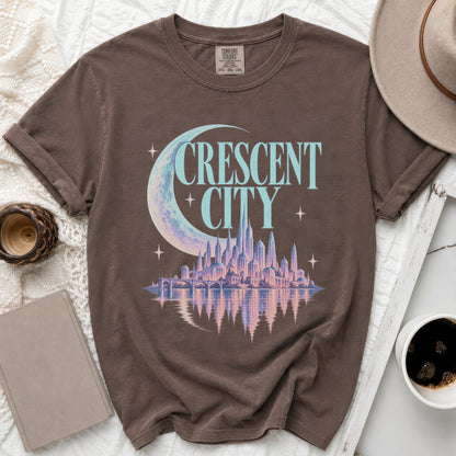 Brown t-shirt with "CRESCENT CITY" text, crescent moon, and city skyline graphic.