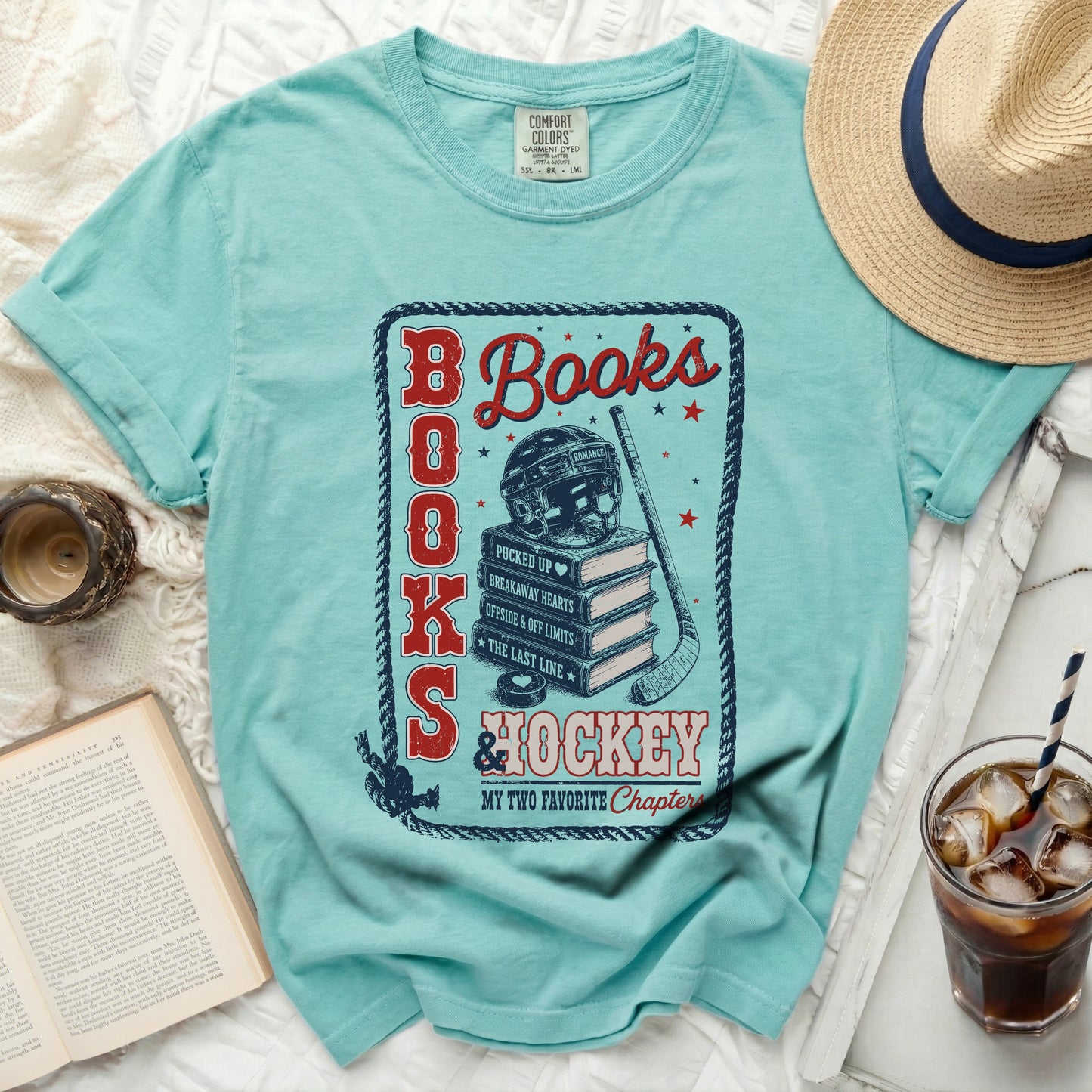 Aqua t-shirt with "Books & Hockey" graphic featuring a hockey helmet, puck, and stacked books.