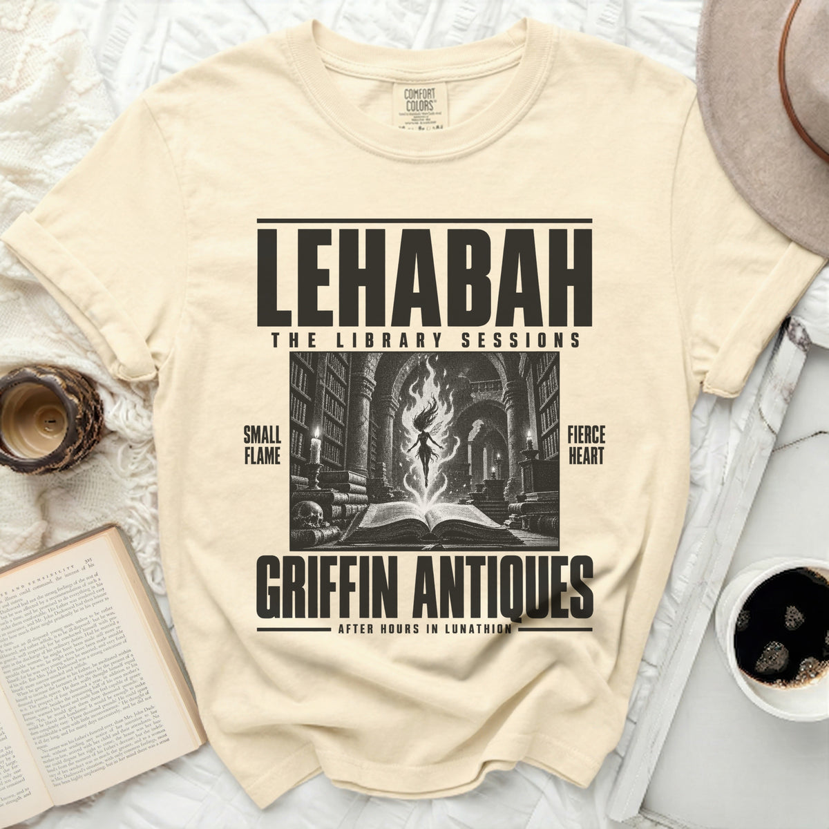 Beige t-shirt with "LEHABAH THE LIBRARY SESSIONS" and a mystical library graphic.