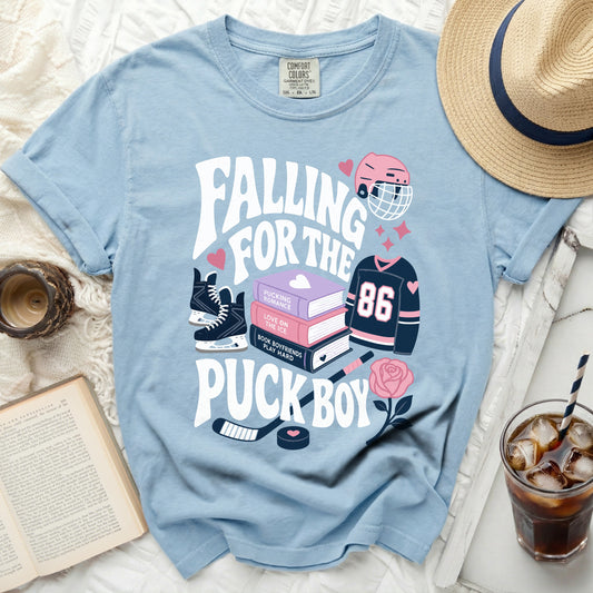 Light blue t-shirt with "Falling for the Puck Boy" text and hockey graphics.