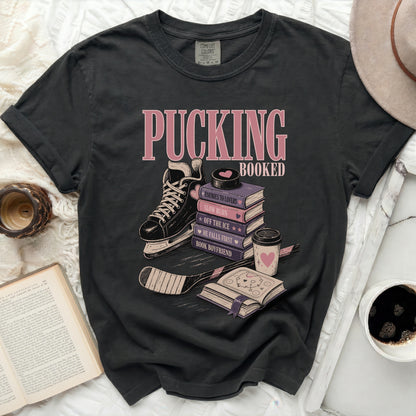 Black t-shirt with "Pucking Booked" and book-themed hockey illustrations.