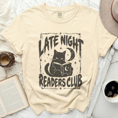 Cream t-shirt with black graphic of a cat reading a book, moon, and text "LATE NIGHT READERS CLUB".