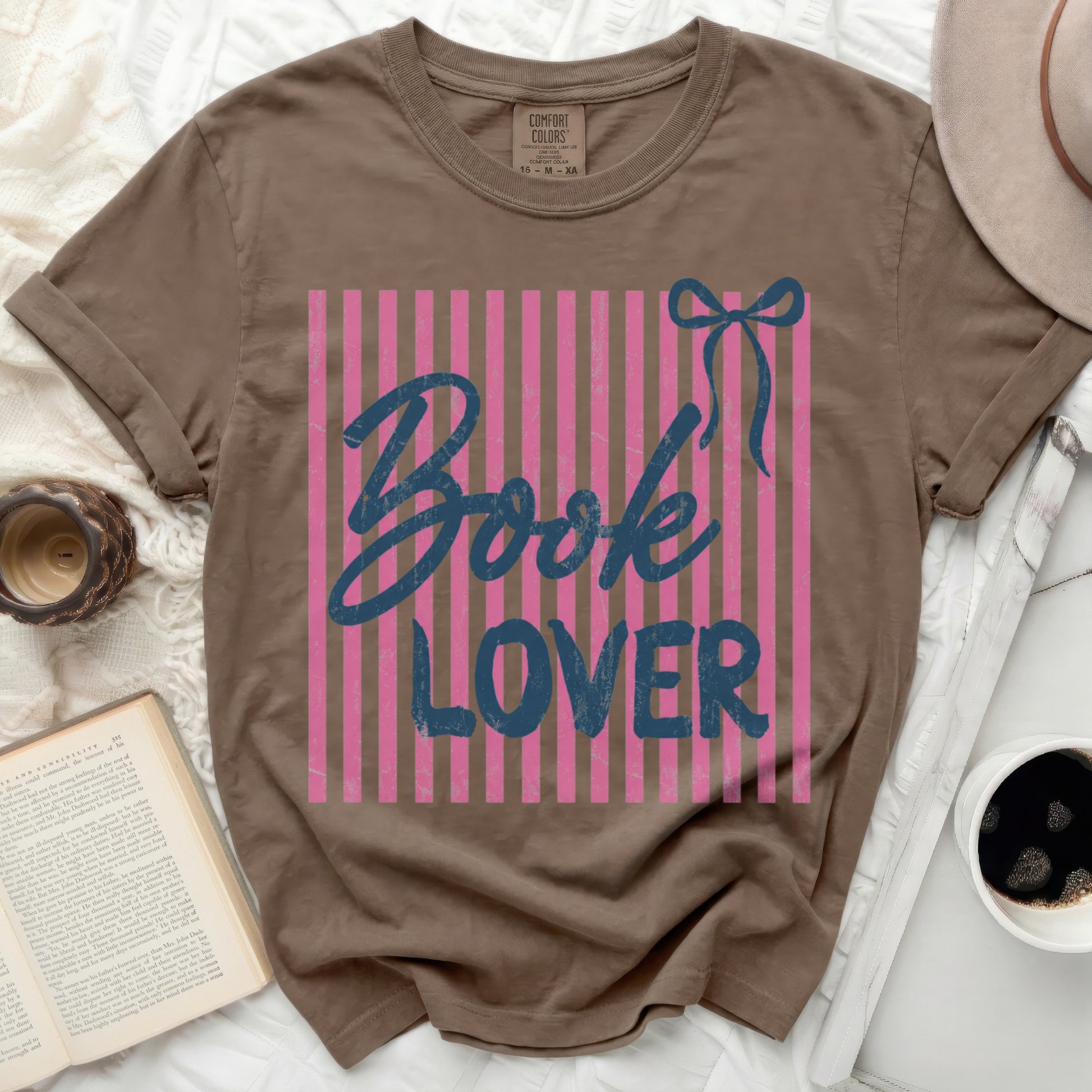 Brown t-shirt with pink stripes and "Book Lover" text and bow graphic.