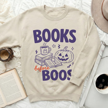 Khaki sweatshirt with "Books before Boos" Halloween graphic.