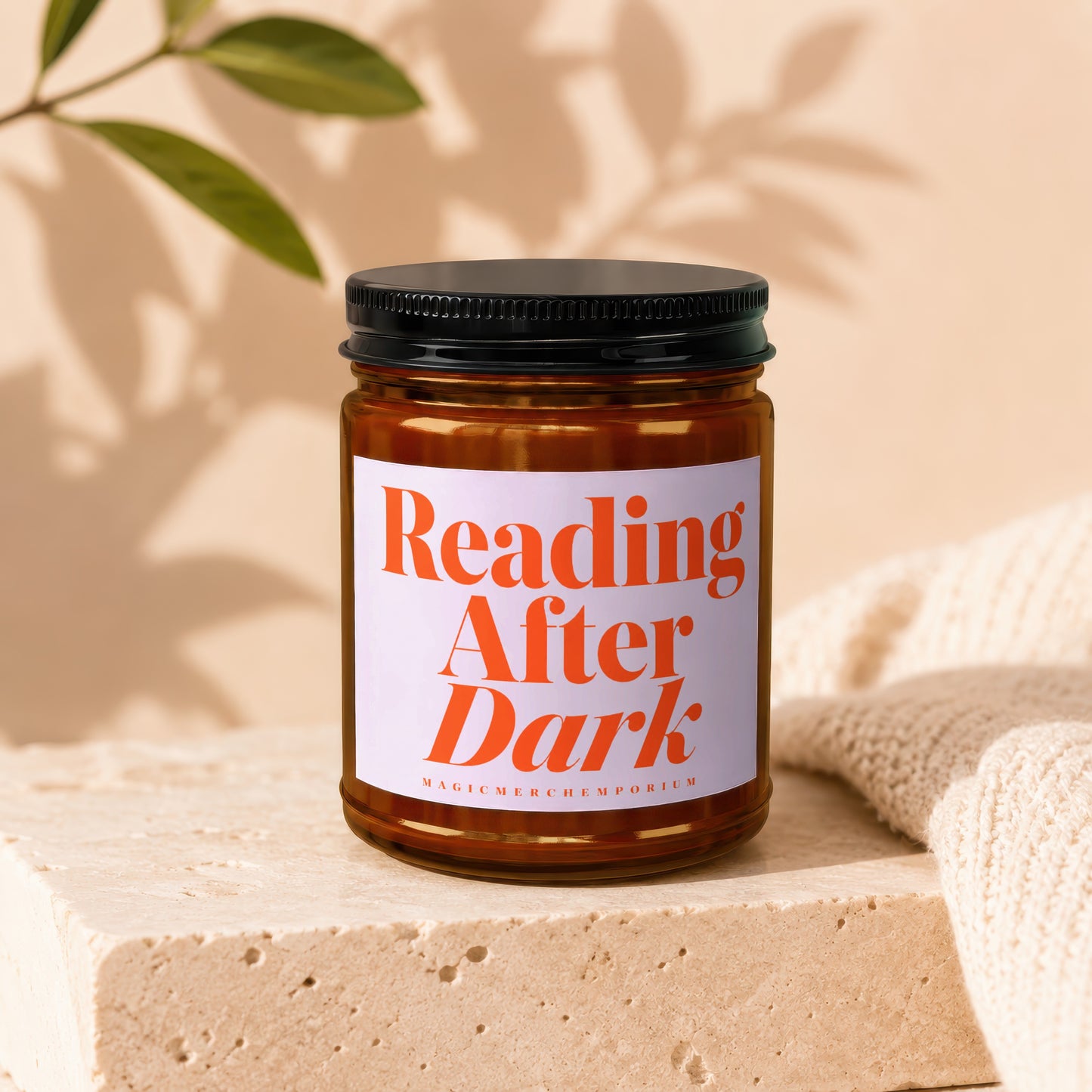 Brown glass candle labeled "Reading After Dark" on a stone block.