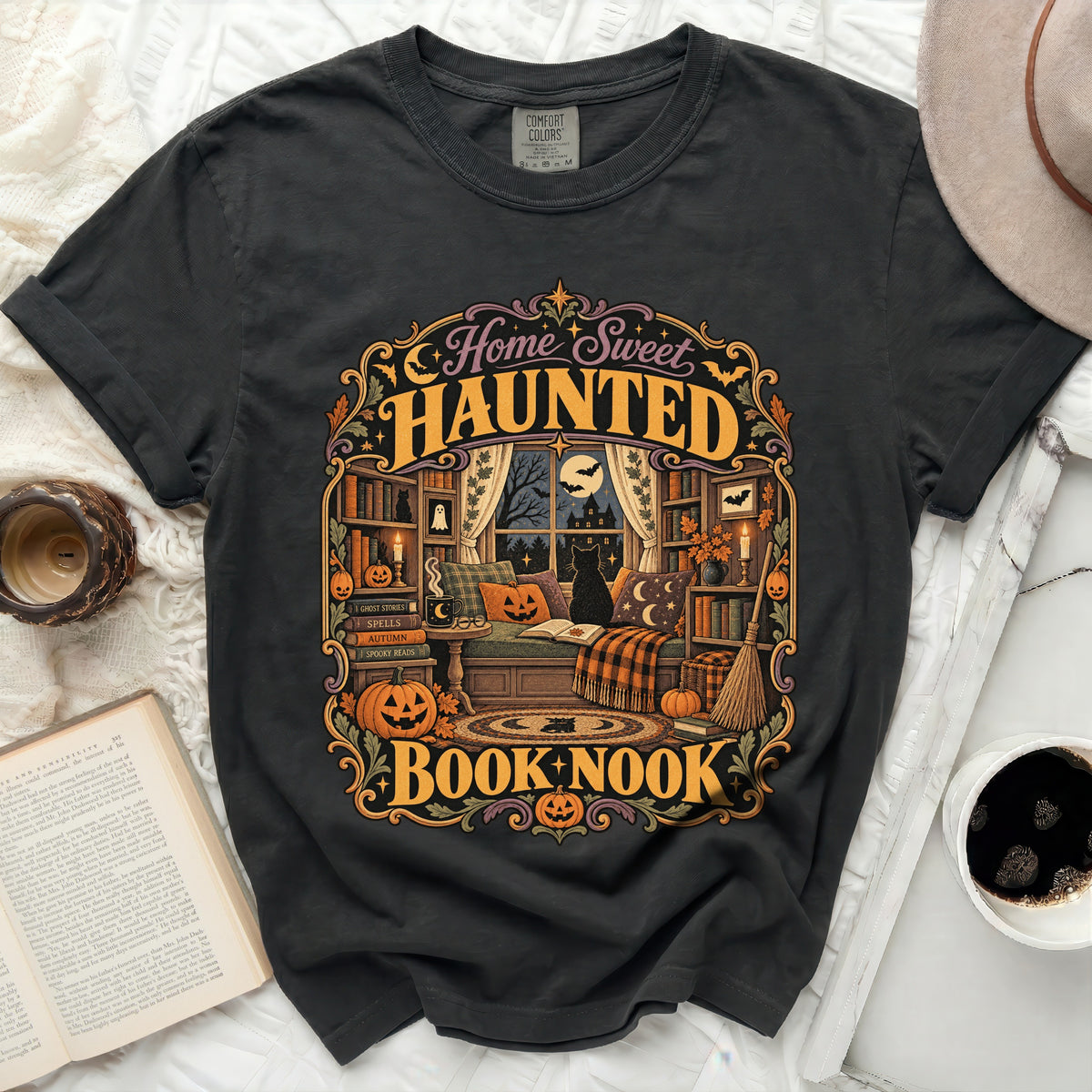 Dark t-shirt with "Home Sweet Haunted Book Nook" Halloween graphic.