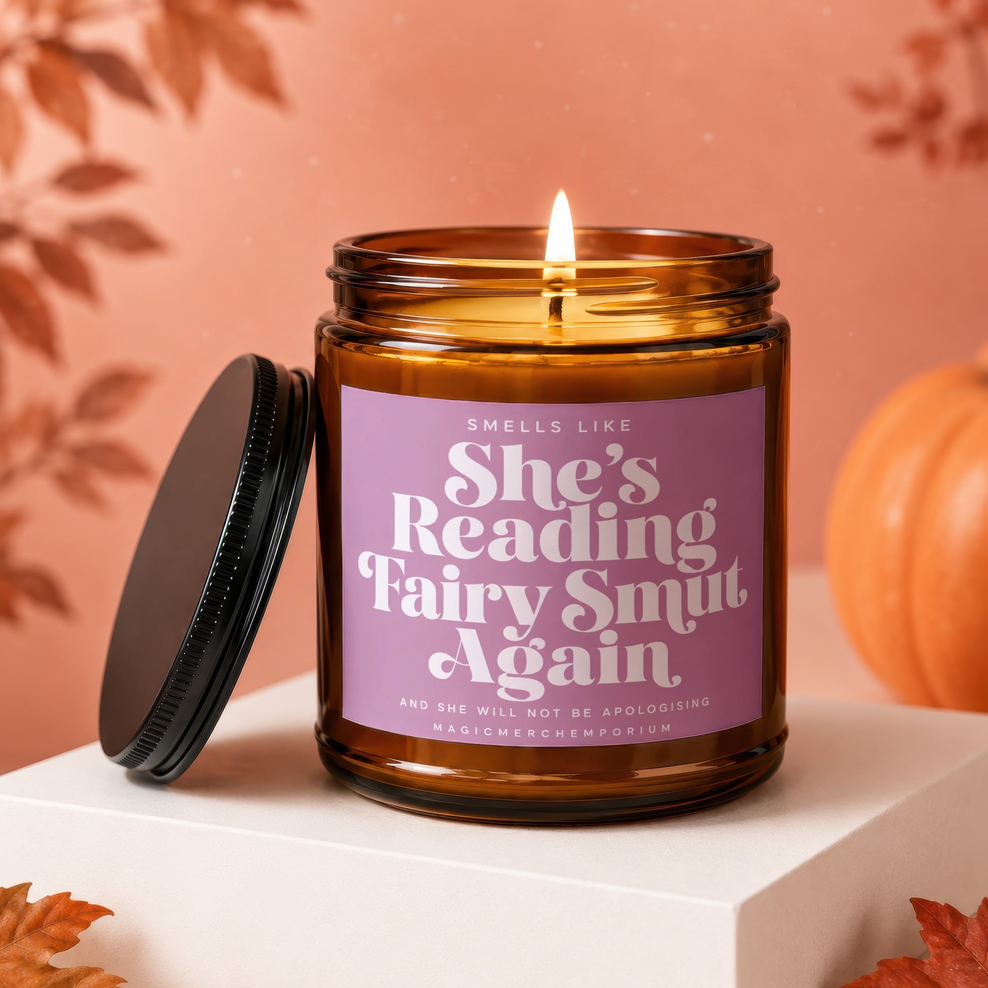 Burning candle with text "Smells Like She's Reading Fairy Smut Again".