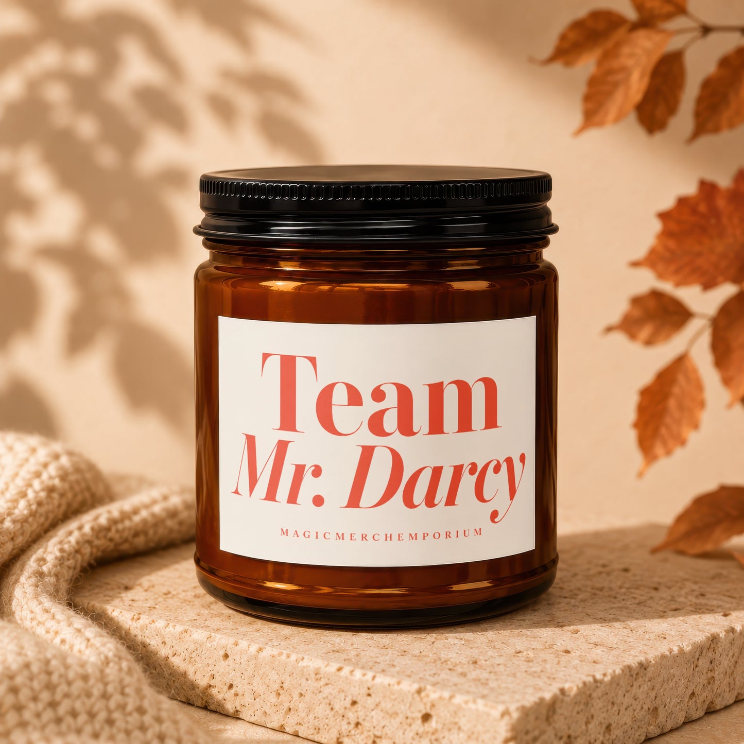 Amber jar candle with black lid, "Team Mr. Darcy" label, and "MagicMerch Emporium" text.