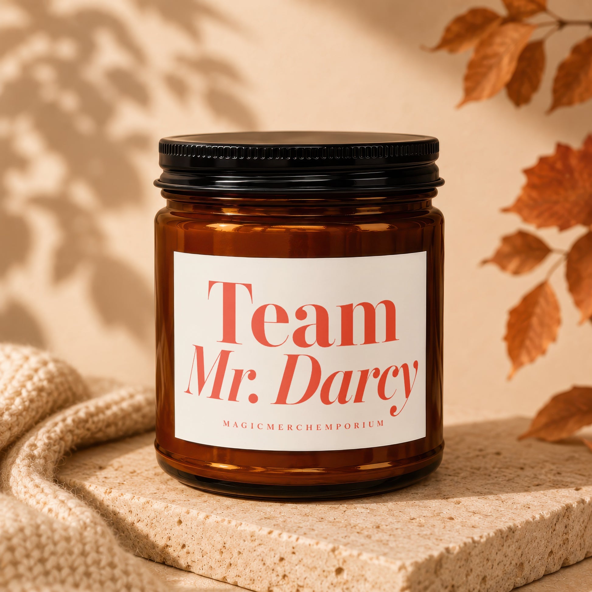 Amber jar candle with black lid, "Team Mr. Darcy" label, and "MagicMerch Emporium" text.