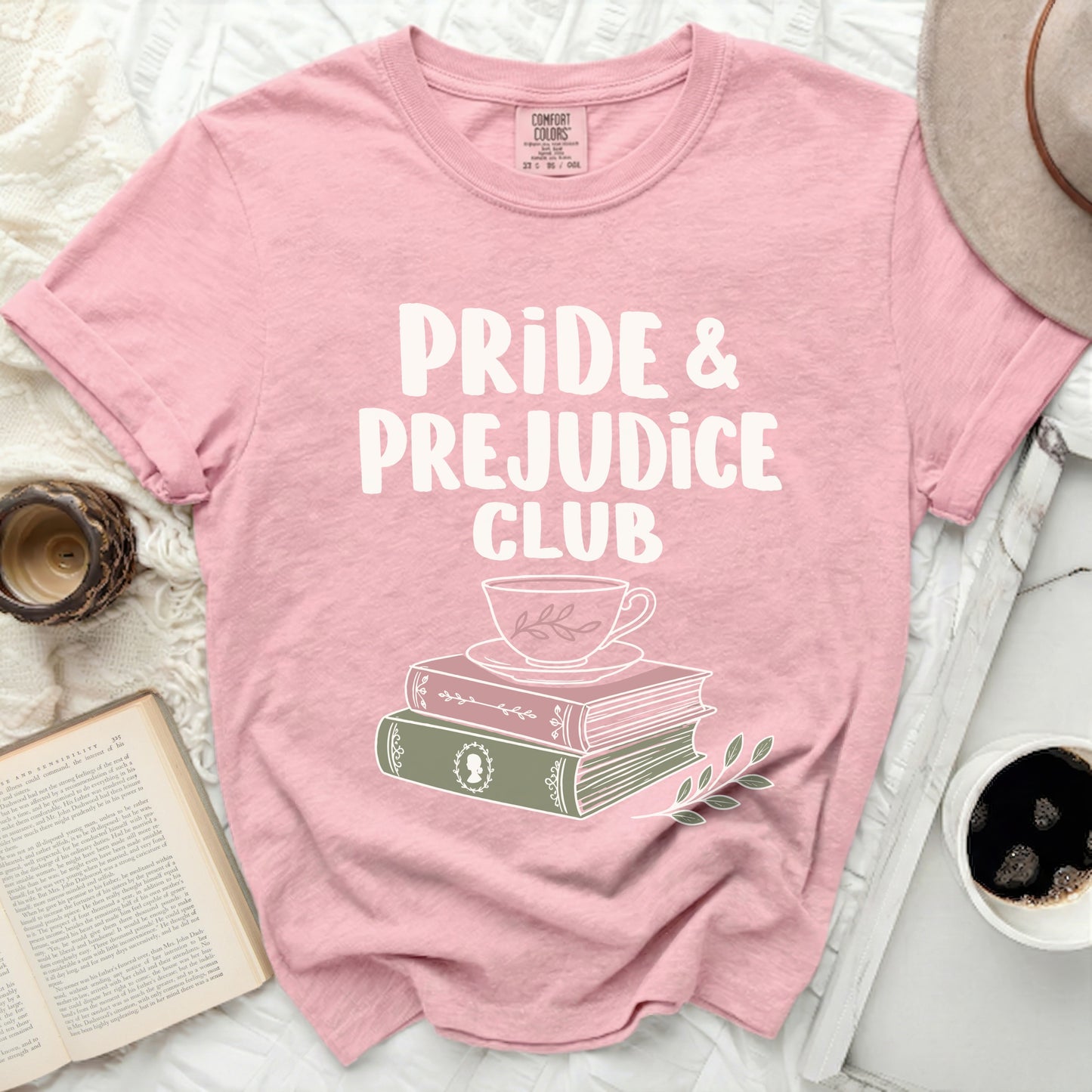 Pink t-shirt with "Pride & Prejudice Club" text and stacked books.