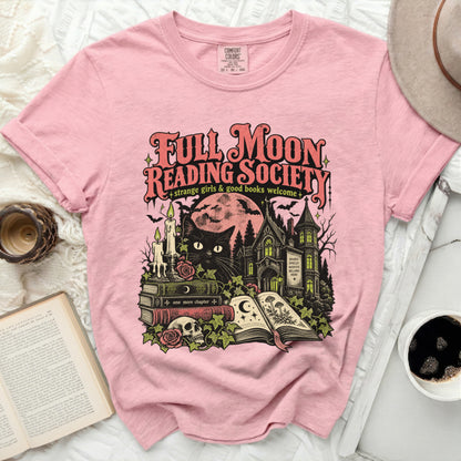 Pink t-shirt with "Full Moon Reading Society" graphic featuring a black cat, books, skull, and haunted house.