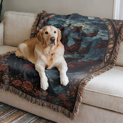 A golden retriever dog is lying on a couch, resting on a colorful, patterned blanket.
