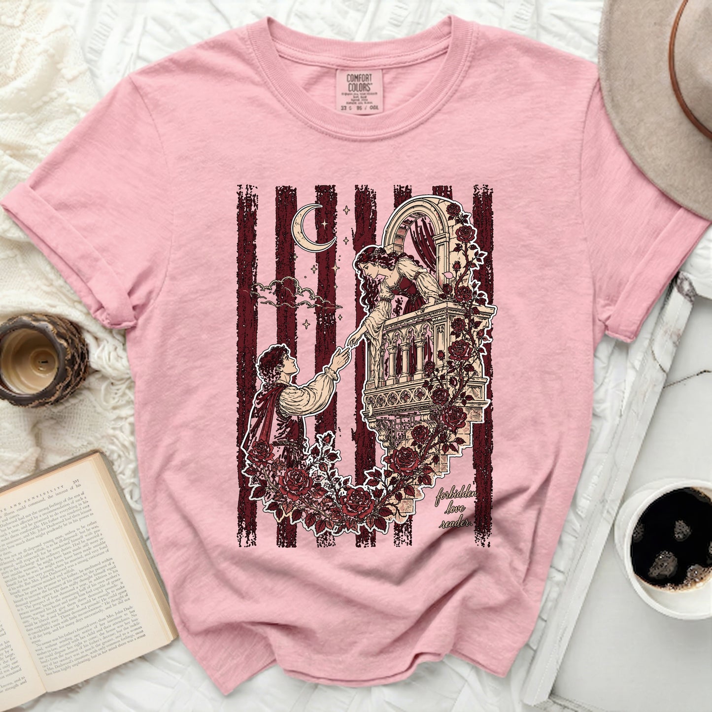 Pink t-shirt with romantic balcony scene and "forbidden love" text.