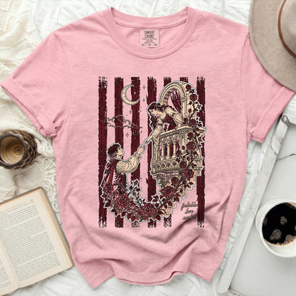 Pink t-shirt with romantic balcony scene and "forbidden love" text.