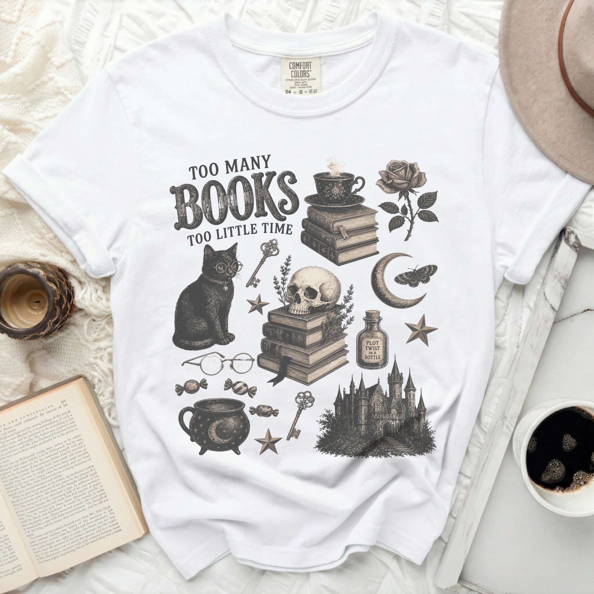 White t-shirt with vintage gothic graphic of cat, skull, books, and text "Too Many Books Too Little Time".