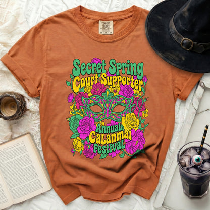 Orange t-shirt with "Secret Spring Court Supporter" and "Annual Calanmai Festival" graphics.