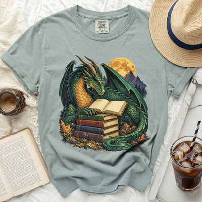 Green dragon reading books in front of full moon and mountains.