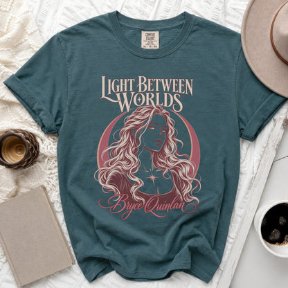 Teal t-shirt with "Light Between Worlds Bryce Quinlan" graphic of a woman.
