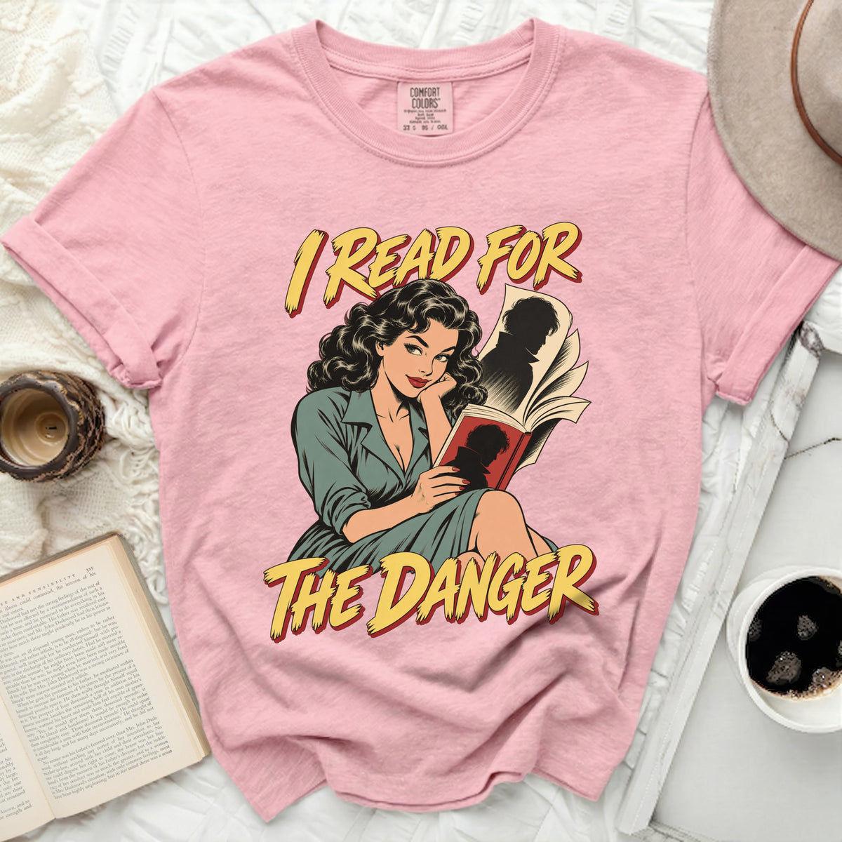 Pink t-shirt with comic-style graphic and text "I READ FOR THE DANGER".