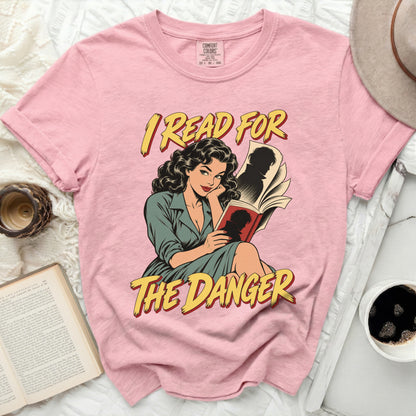 Pink t-shirt with comic-style graphic and text "I READ FOR THE DANGER".