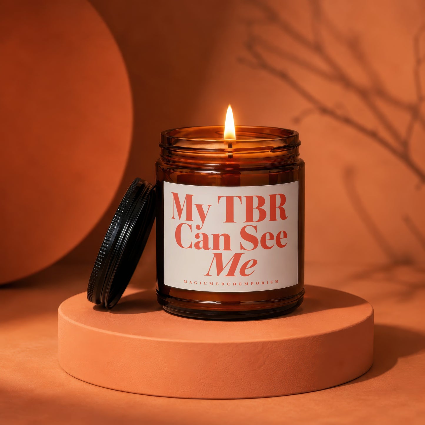 Amber jar candle with lit flame, reads "My TBR Can See Me".