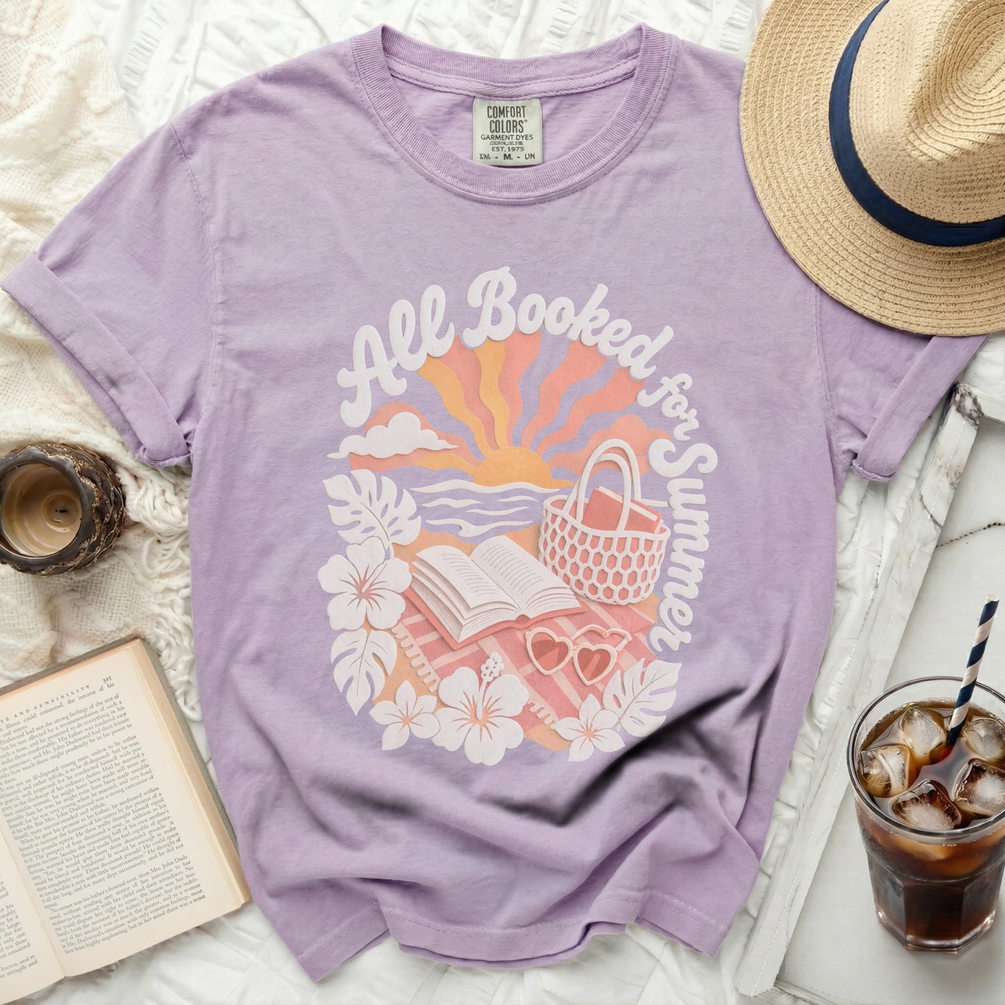 Purple t-shirt with "All Booked for Summer" text and beach imagery.