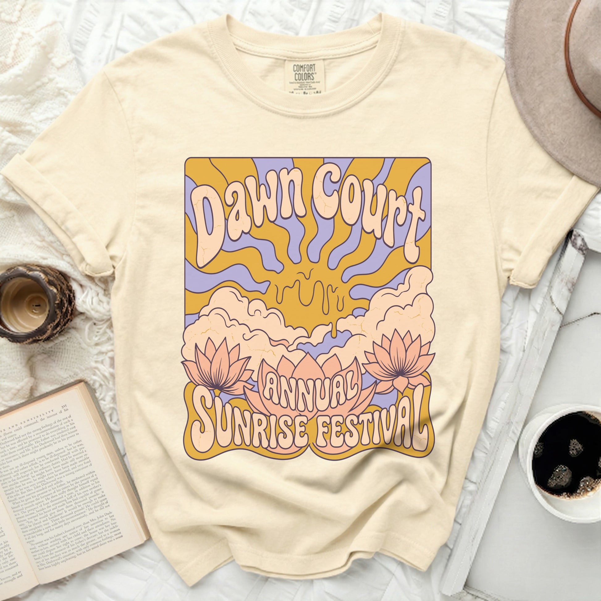 Cream t-shirt with retro "Dawn Court Annual Sunrise Festival" graphic.