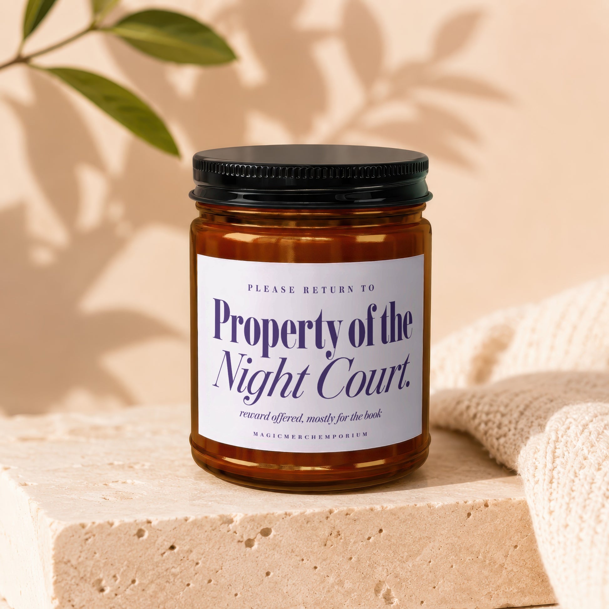 Amber jar candle labeled "Property of the Night Court" with decorative text.