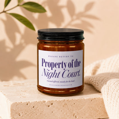 Amber jar candle labeled "Property of the Night Court" with decorative text.
