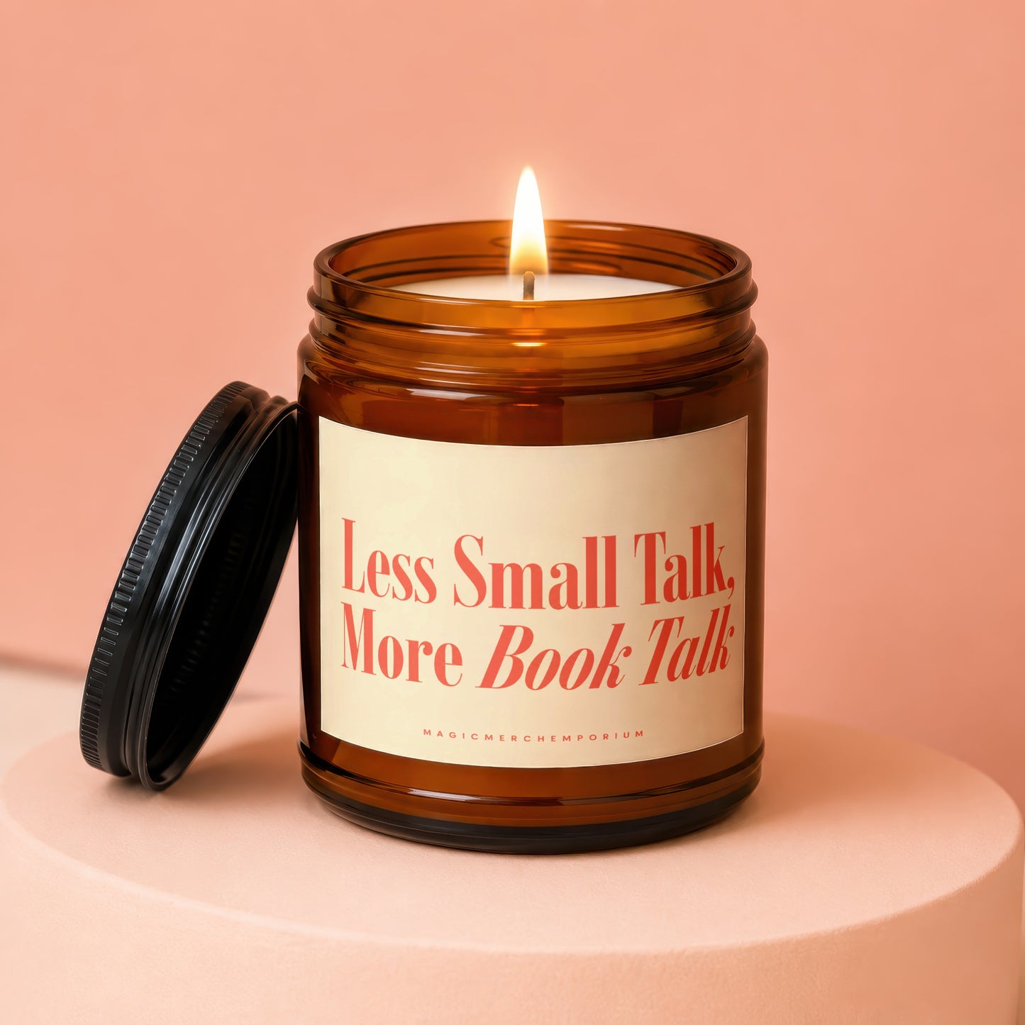 Amber jar candle with lit wick and black lid, text "Less Small Talk, More Book Talk".