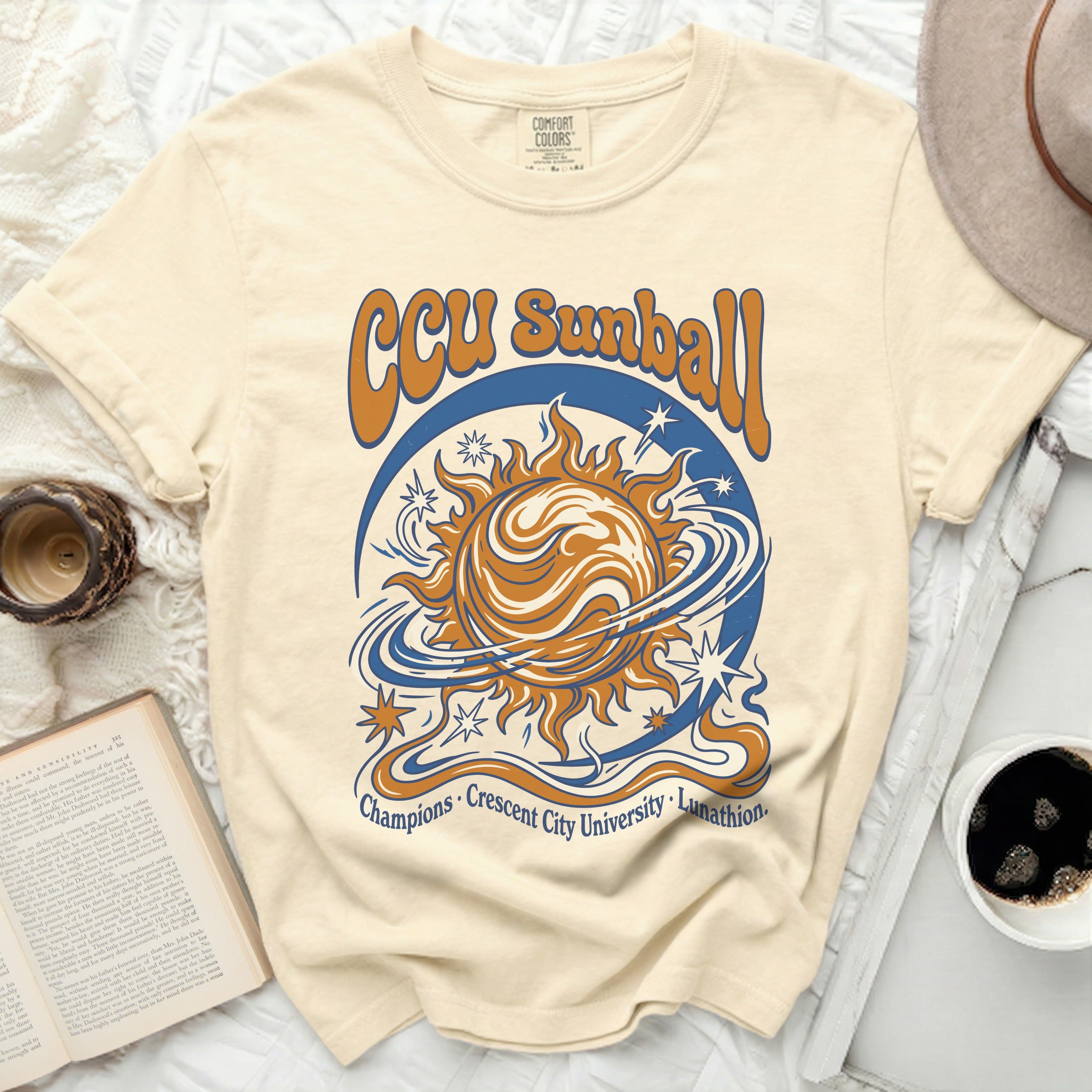 Cream t-shirt with orange and blue sun, stars, and 