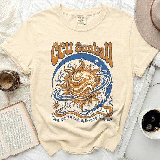 Cream t-shirt with orange and blue sun, stars, and "CCU Sunball" text.