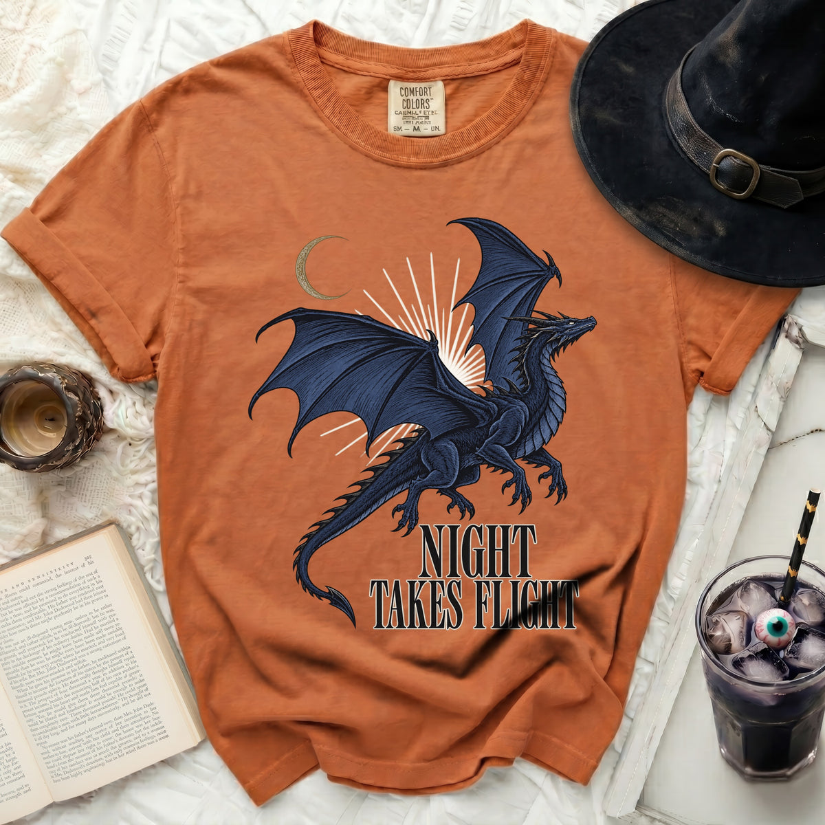 Orange t-shirt with black dragon graphic and "Night Takes Flight" text.