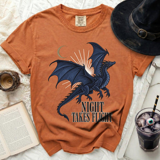 Orange t-shirt with black dragon graphic and "Night Takes Flight" text.