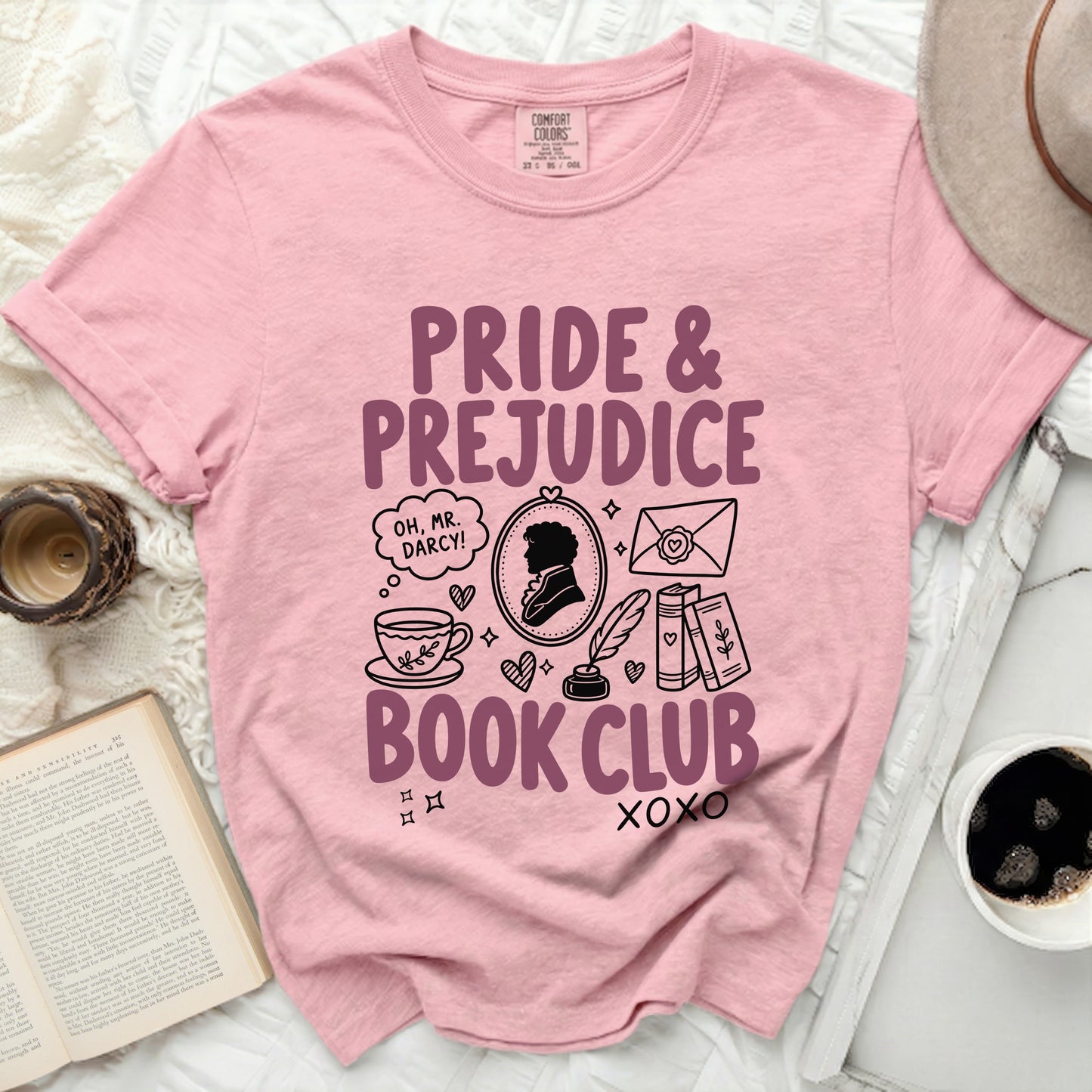 Pink t-shirt with "Pride & Prejudice Book Club" text and literary illustrations.