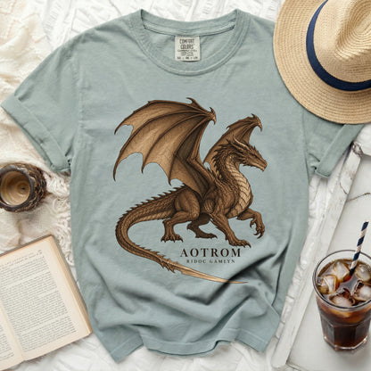 Light blue t-shirt with a brown dragon graphic and text "AOTROM RIDOC GAMLYN".