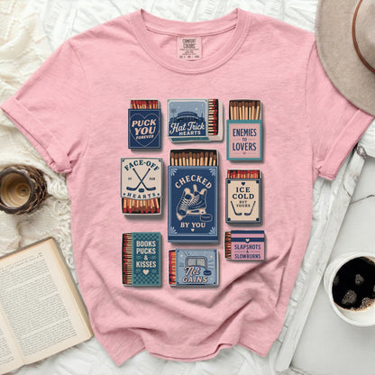 Pink t-shirt with hockey-themed matchbox designs.