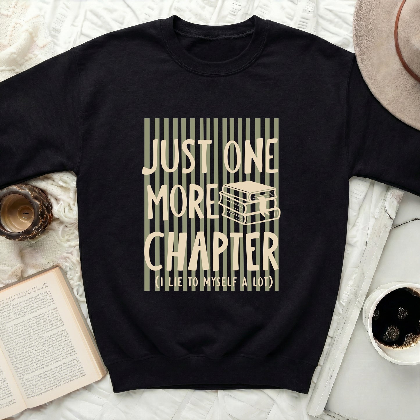 Black sweatshirt with "JUST ONE MORE CHAPTER (I LIE TO MYSELF A LOT)" text.