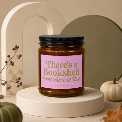 Amber candle with pink label reading "There's a Bookshelf Somewhere in There".