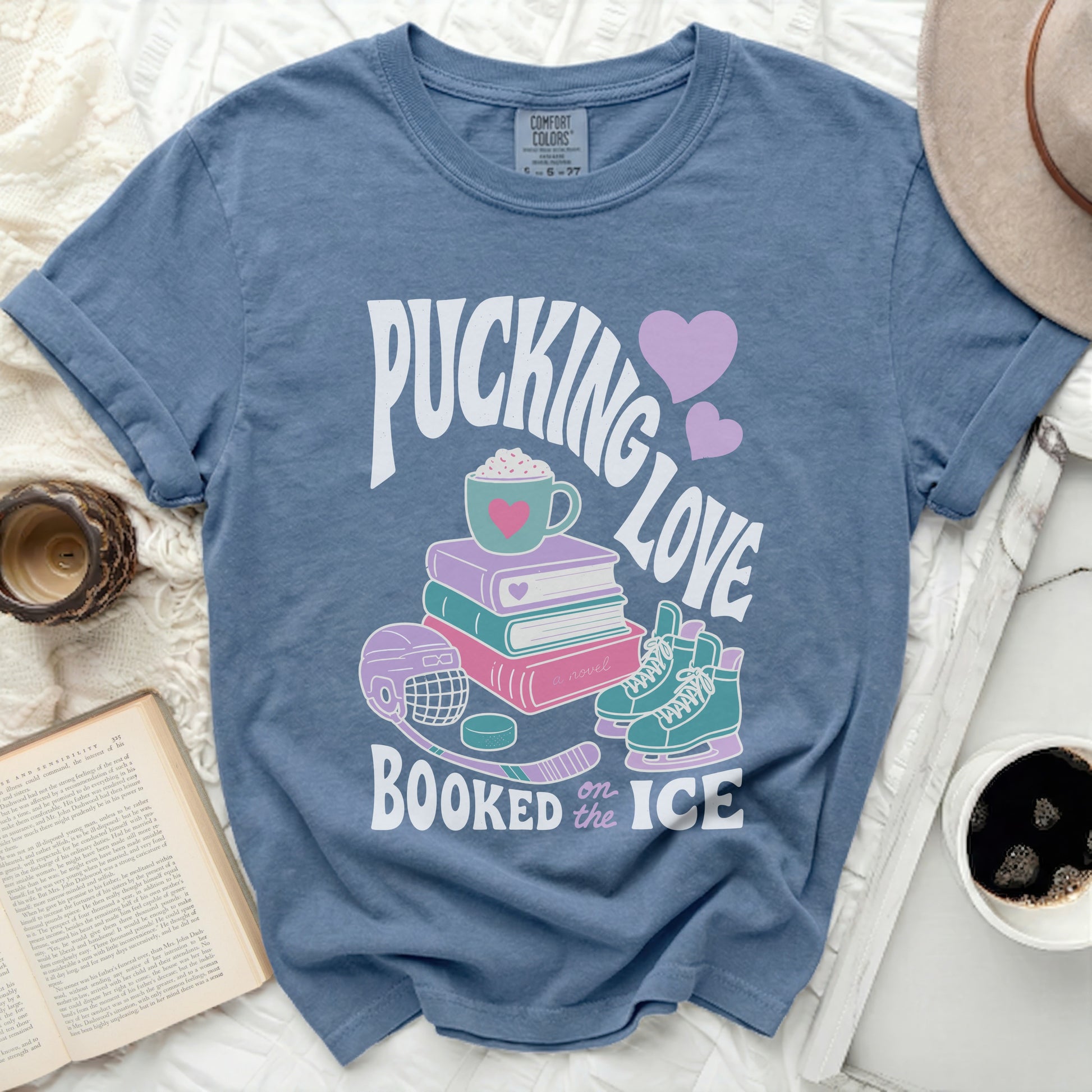 Blue t-shirt with "Pucking Love Booked on the Ice" and hockey graphics.