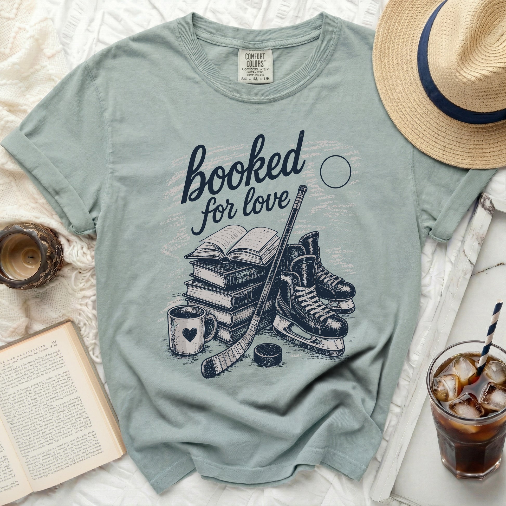 T-shirt with "booked for love" text, books, hockey skates, and puck.